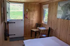 Shepherd's hut double bed and view of the hills