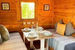 Shepherd's hut dining area that converts to single beds Shepherd's hut dining area that converts to single beds