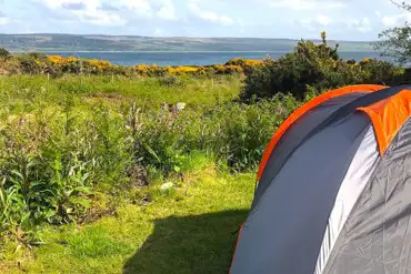 Small non electric grass tent pitches with sea views