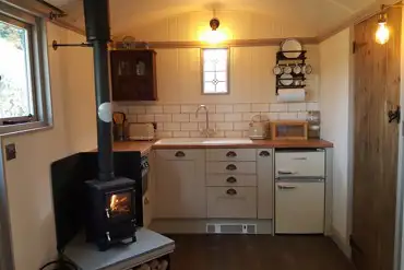 kitchen with log burner and plinth heater
