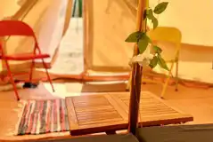 Bell tent interior with table and chairs