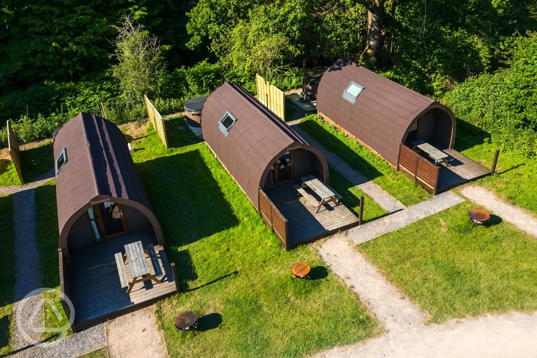 Aerial of the glamping pods with outdoor firepits