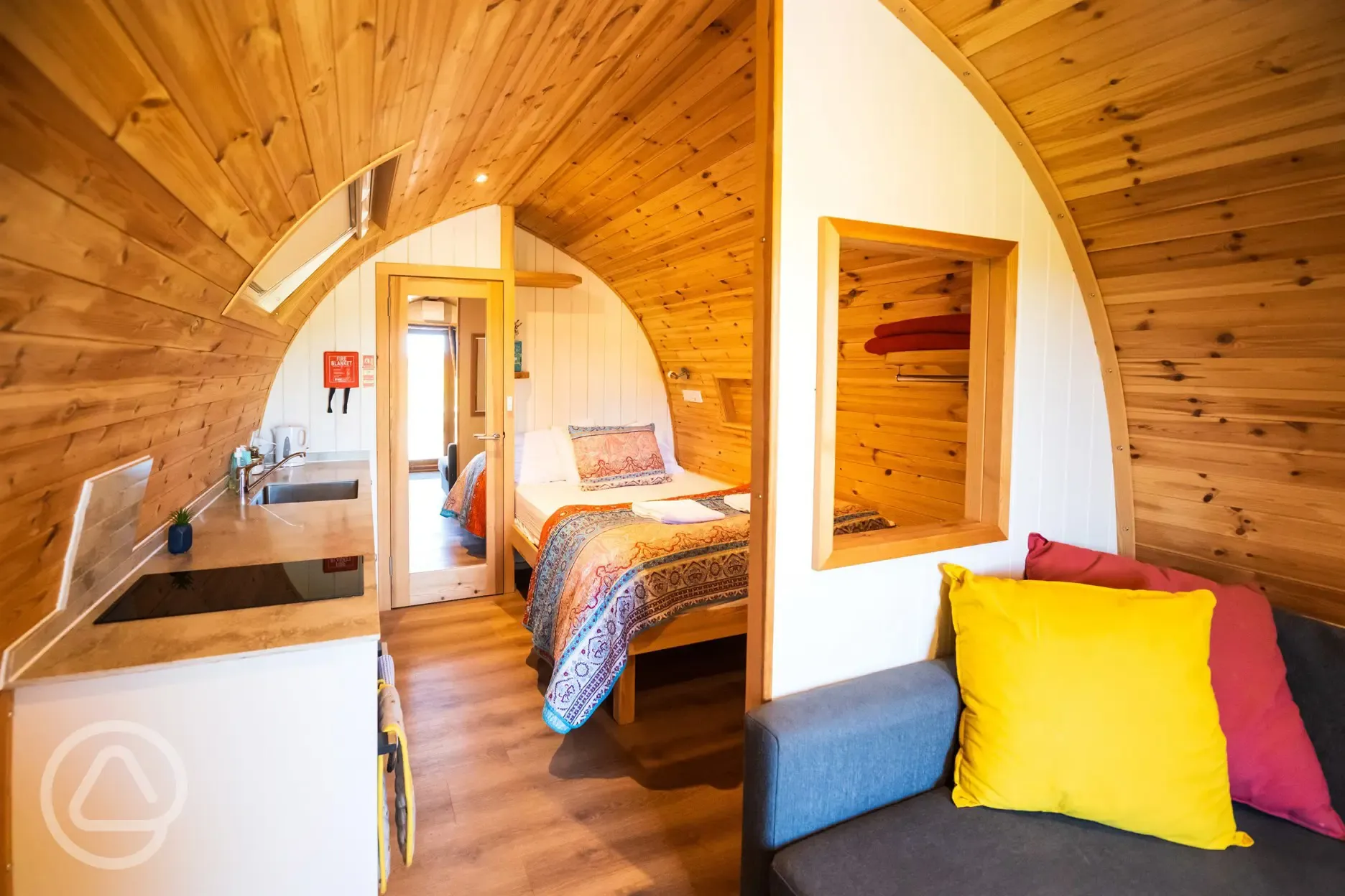 Ensuite glamping pod interior with double bed, kitchenette and living area