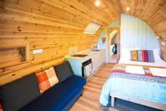 Chimpanzee large ensuite glamping pod interior with double bed and living area