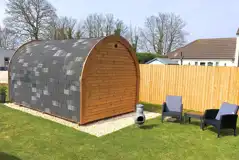 Camping pod with an outdoor seating area and chimenea Camping pod with an outdoor seating area and chimenea