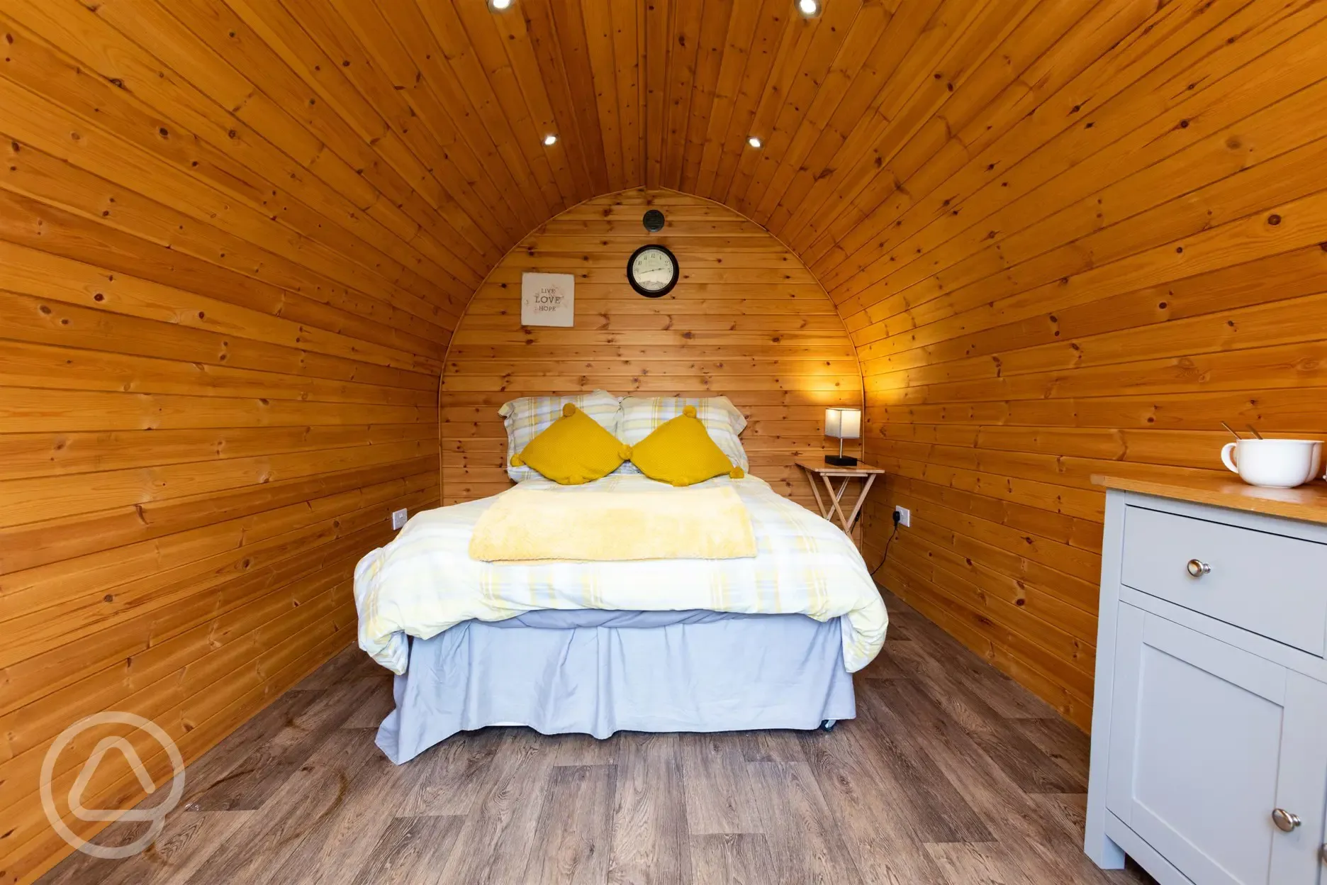 Camping pod interior with a double and bedding Camping pod interior with a double and bedding