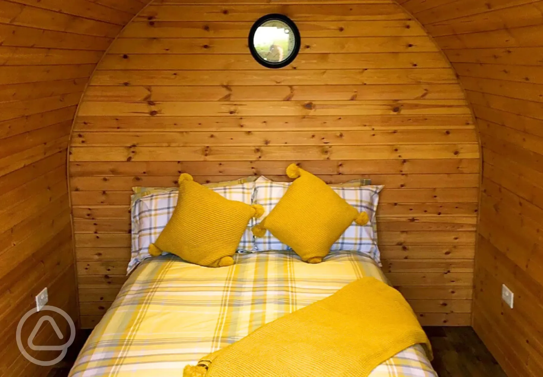 Camping pod interior with a double and bedding Camping pod interior with a double and bedding