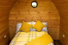 Camping pod interior with a double and bedding