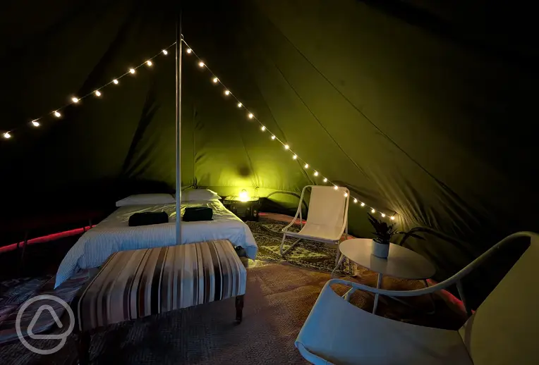 Bell view bell tent with a double bed and fairy lights