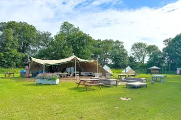 Stretch tent with large communal fire pit and outdoor seating