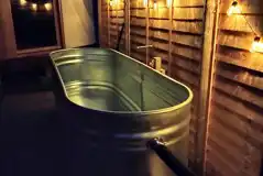 Yurts outdoor wood-fired hot tub with fairy lights at night Yurts outdoor wood-fired hot tub with fairy lights at night