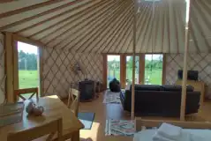 7m luxury European yurt dining and living area with a TV and wood-burner 7m luxury European yurt dining and living area with a TV and wood-burner