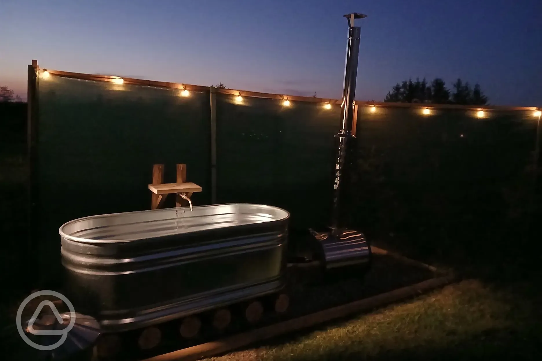 Wood fired hot tub at night 