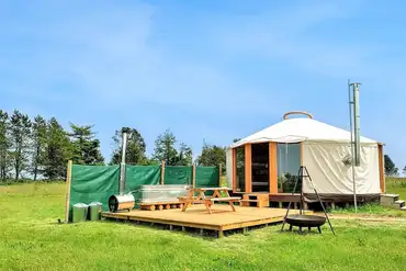 7m luxury European yurt exterior with outdoor tub and fire pit