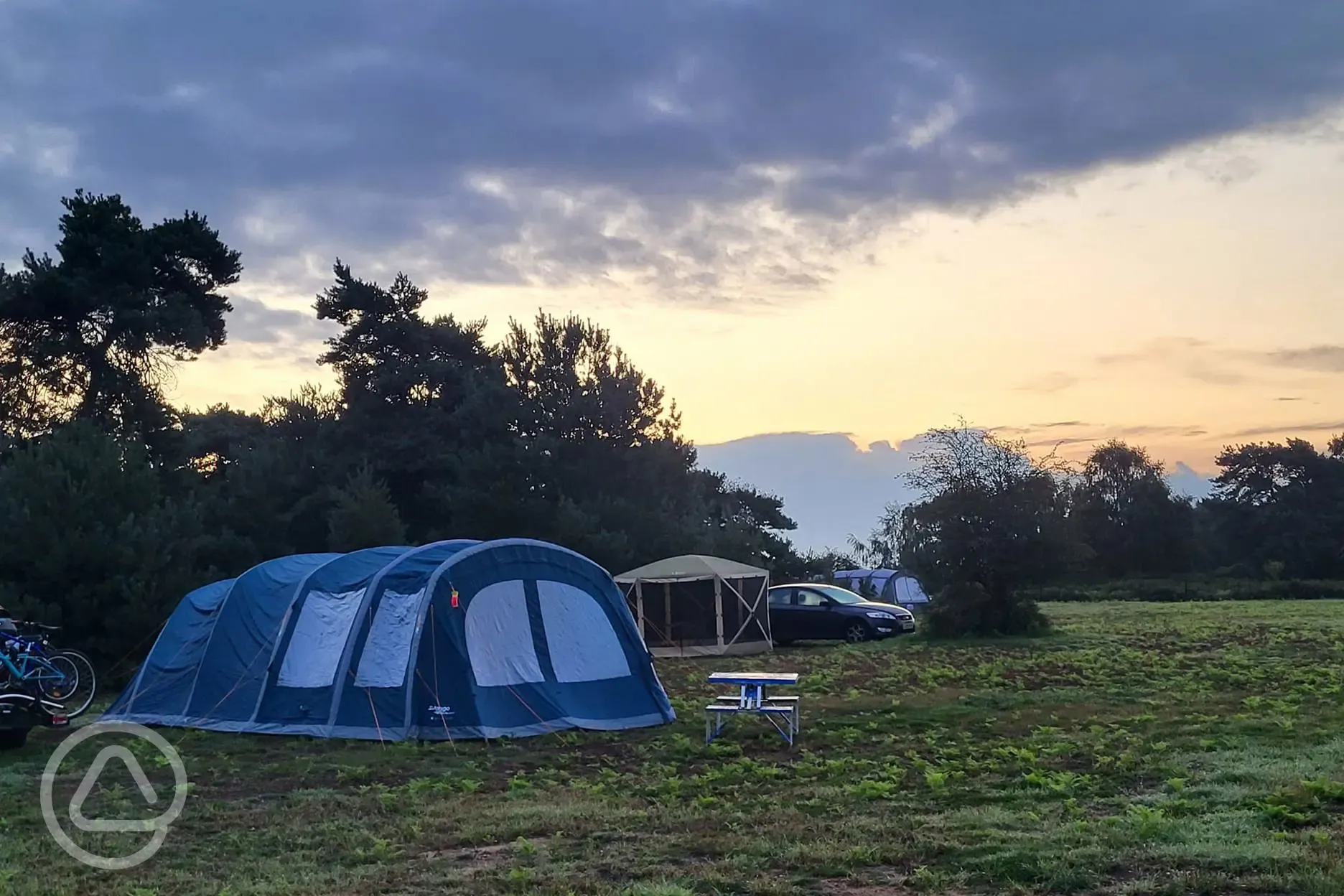 Grass tent pitch at sunset