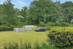 Non electric grass tent pitches surrounded by trees