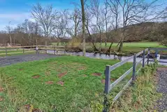 Riverside electric hardstanding pitches with 16amp electric and grass area 