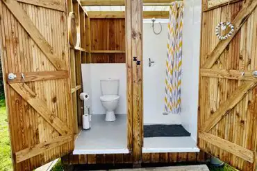 Private toilet and shower for each bell tent