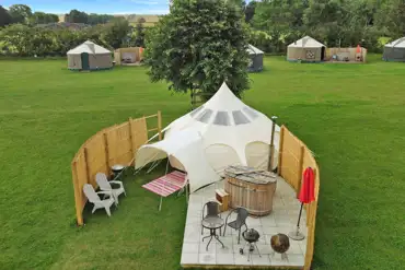 Aerial of stargazer bell tent with hot tub and outdoor seating