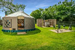 Yurt exterior with outdoor seating and raised BBQ provided Yurt exterior with outdoor seating and raised BBQ provided