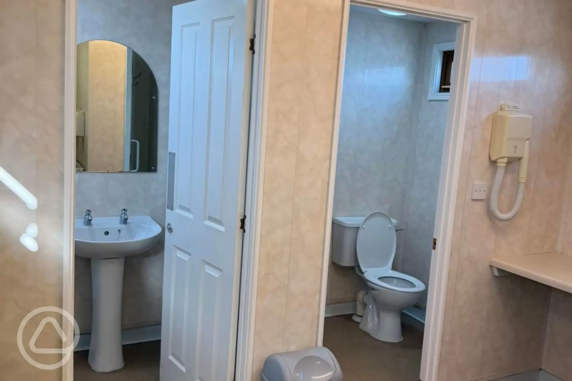 Toilets with sinks, mirrors and hairdryers Toilets with sinks, mirrors and hairdryers