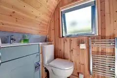 Ensuite with a flushing toilet, shower, hand basin and a heated towel rail