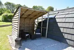 Pen-y-ghent glamping pod with a picnic bench and covered outdoor area