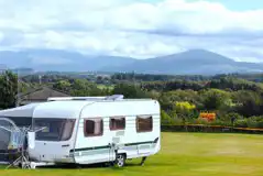 Caravan on an electric grass pitch with a 10 amp hook up Caravan on an electric grass pitch with a 10 amp hook up