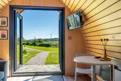 Glamping pod dining area and TV Glamping pod dining area and TV