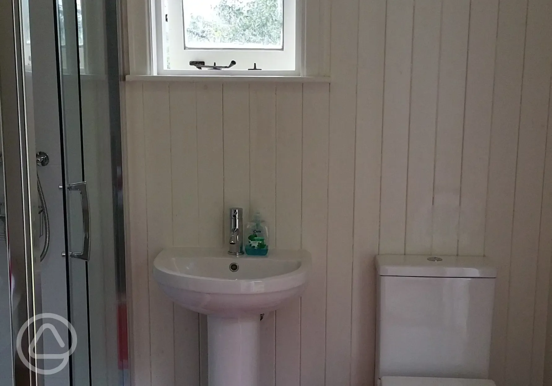 Shepherd's hut ensuite shower room with toilet and basin