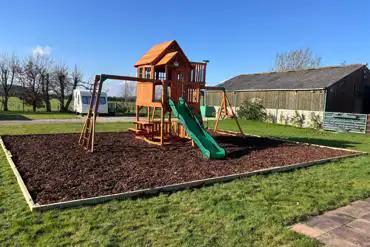 Children's play park with climbing frame at Midsummer Caravan and Camping