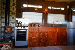 The Showman's Ensuite Caravan (Lola) kitchen area and log burner The Showman's Ensuite Caravan (Lola) kitchen area and log burner