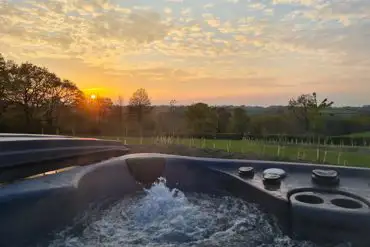 Safari tent hot tub at sunset