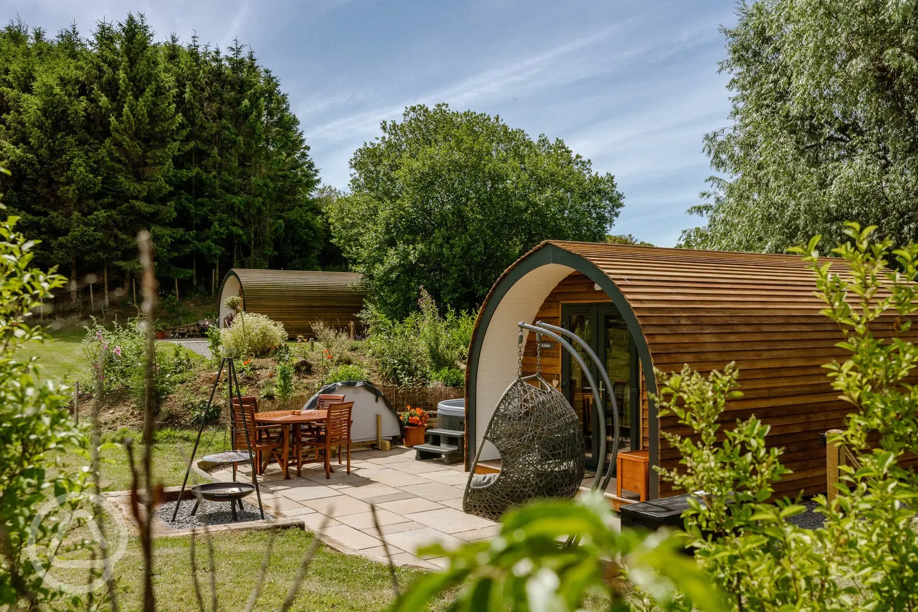 Glamping pods with private fire pits and seating