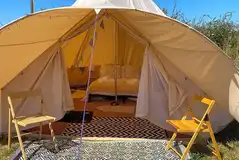 Part furnished bell tents with a double bed and optional airbeds