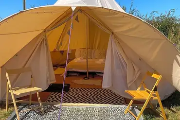 Part furnished bell tents with a double bed and optional airbeds