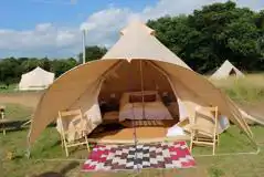 Part furnished bell tents with a double bed and optional airbeds