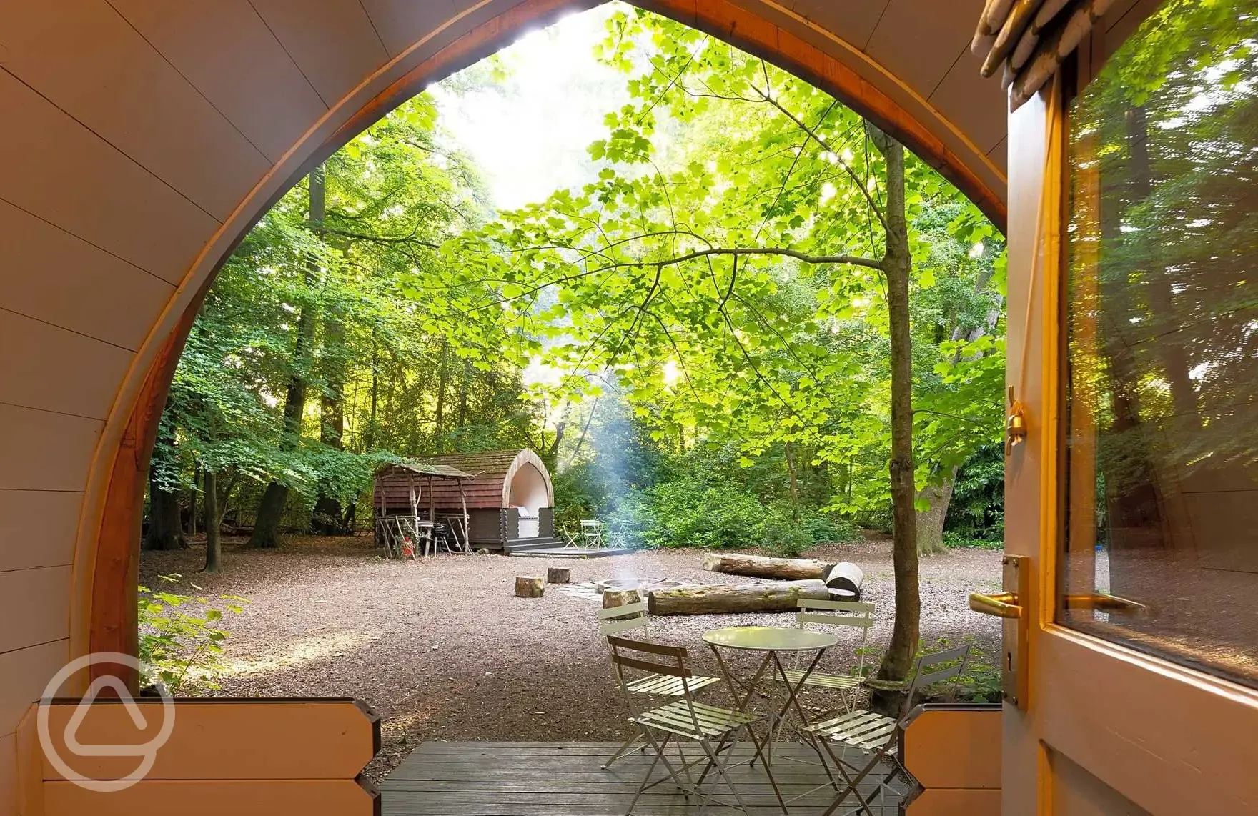 View from Daisy camping pod into the main clearing with firepit