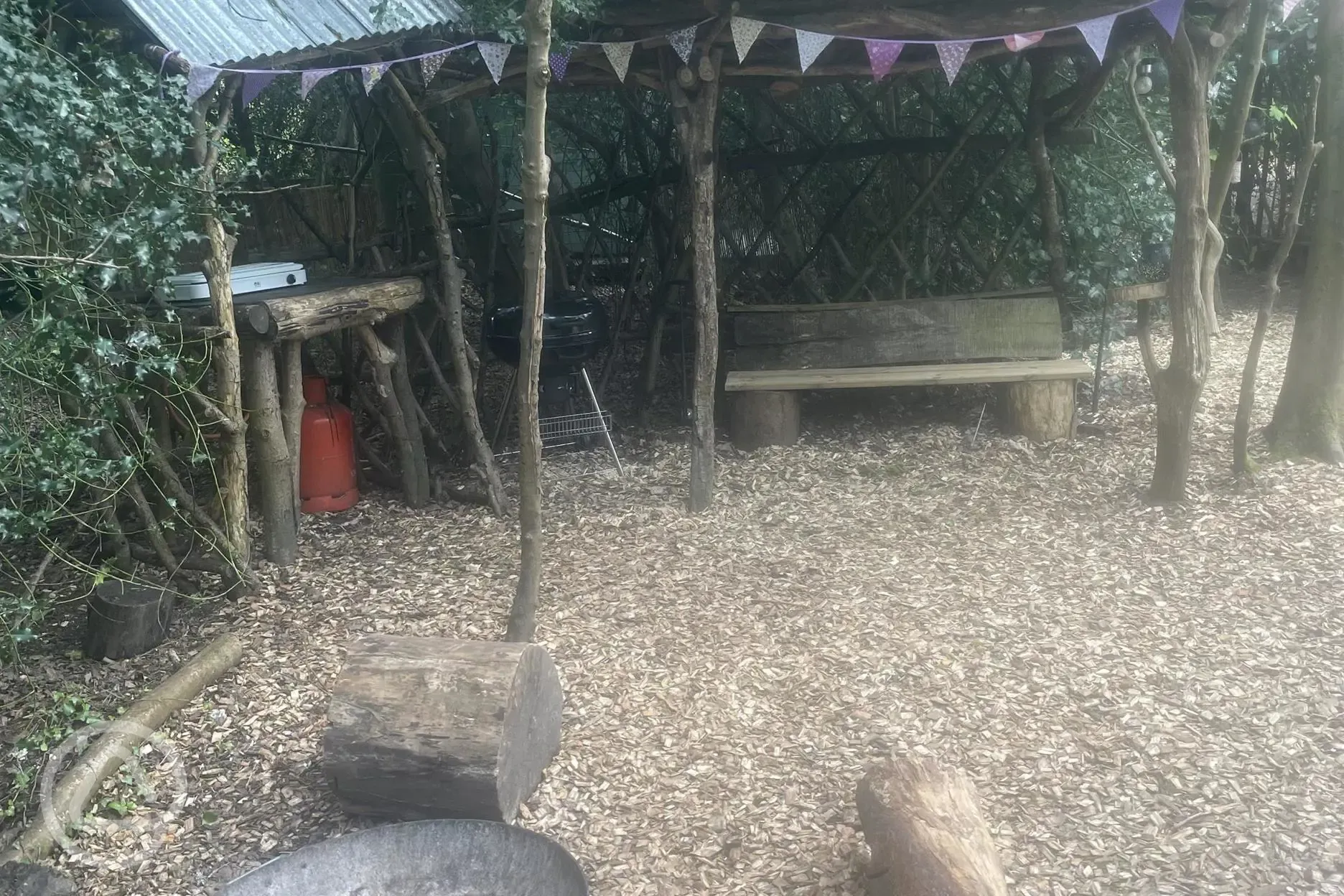 Bedouin bell tent under cover cooking and seating area