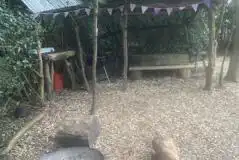 Bedouin bell tent under cover cooking and seating area