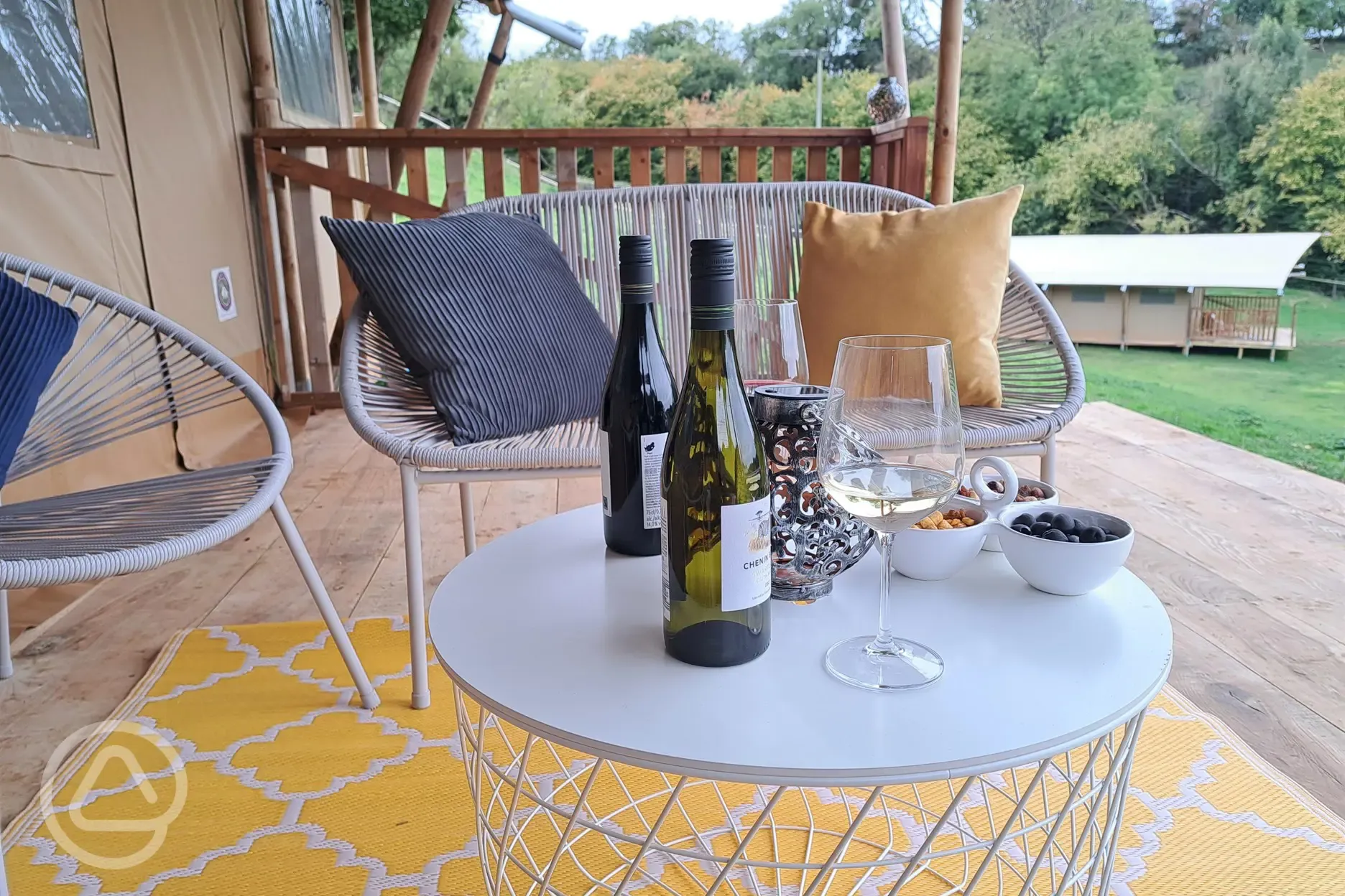 relax on the veranda of Grisway Lodge with wine and nibbles