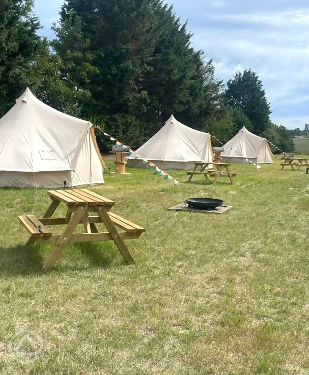 Bell tents with fire pits and picnic benches