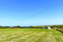 Non electric grass pitches with distant sea views