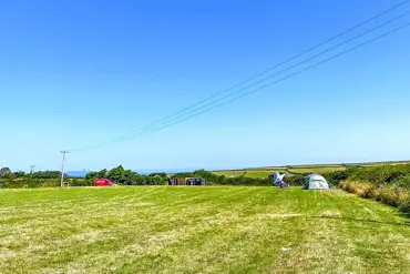 Non electric grass pitches with distant sea views
