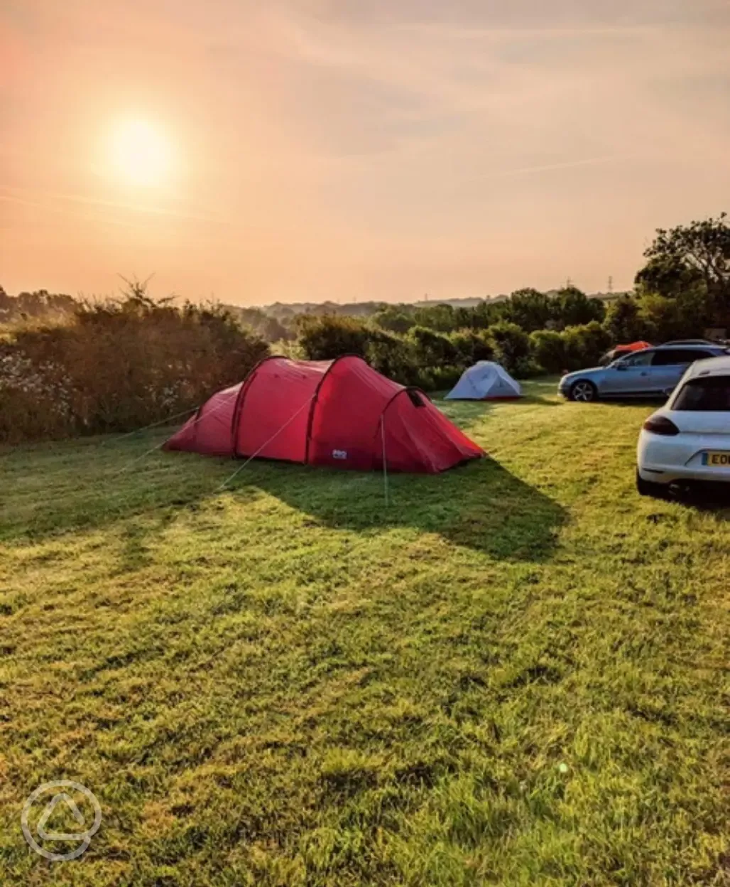 Non electric grass tent pitches at sunset