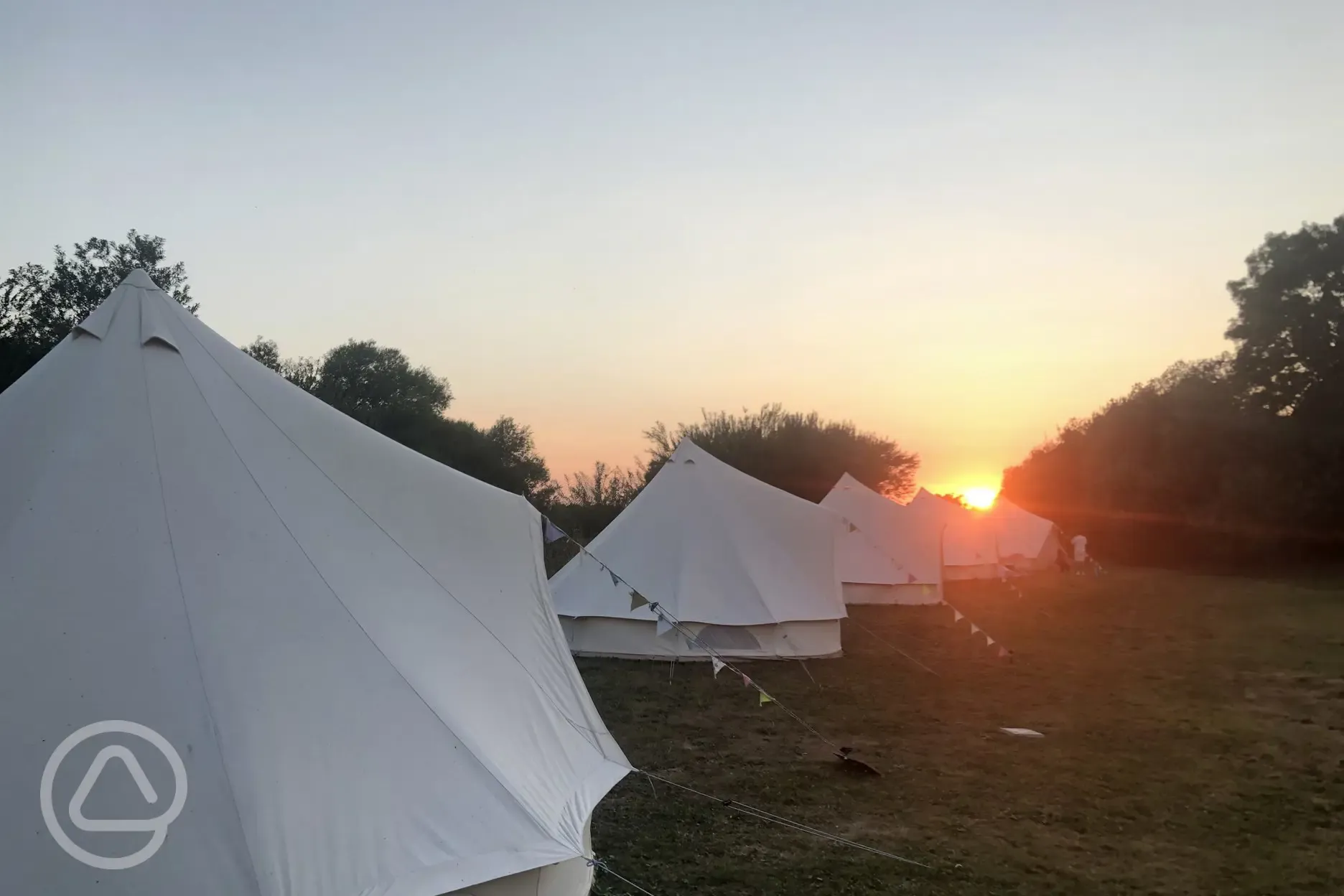 Unfurnished bell tents at sunset