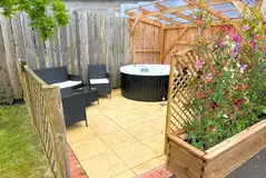 Squirrel pod outdoor patio with a hot tub