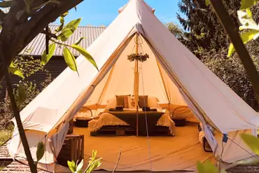 Sorrel bell tent in a private glade with a double bed and camp beds