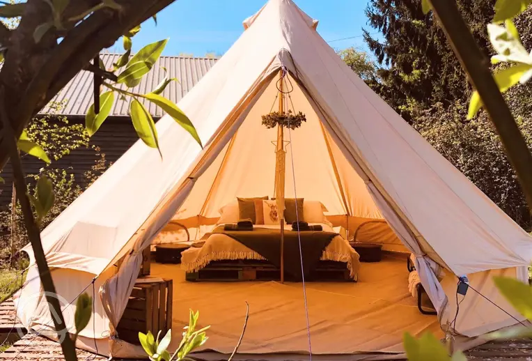 Sorrel bell tent in a private glade with a double bed and camp beds