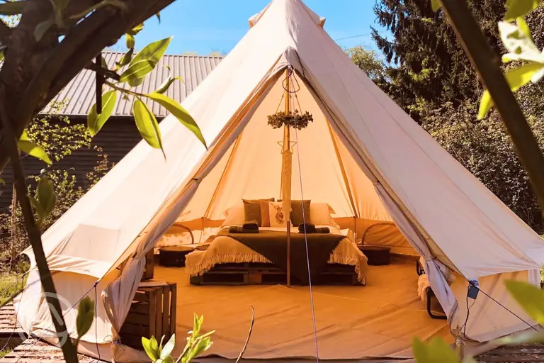Sorrel bell tent in a private glade with a double bed and camp beds